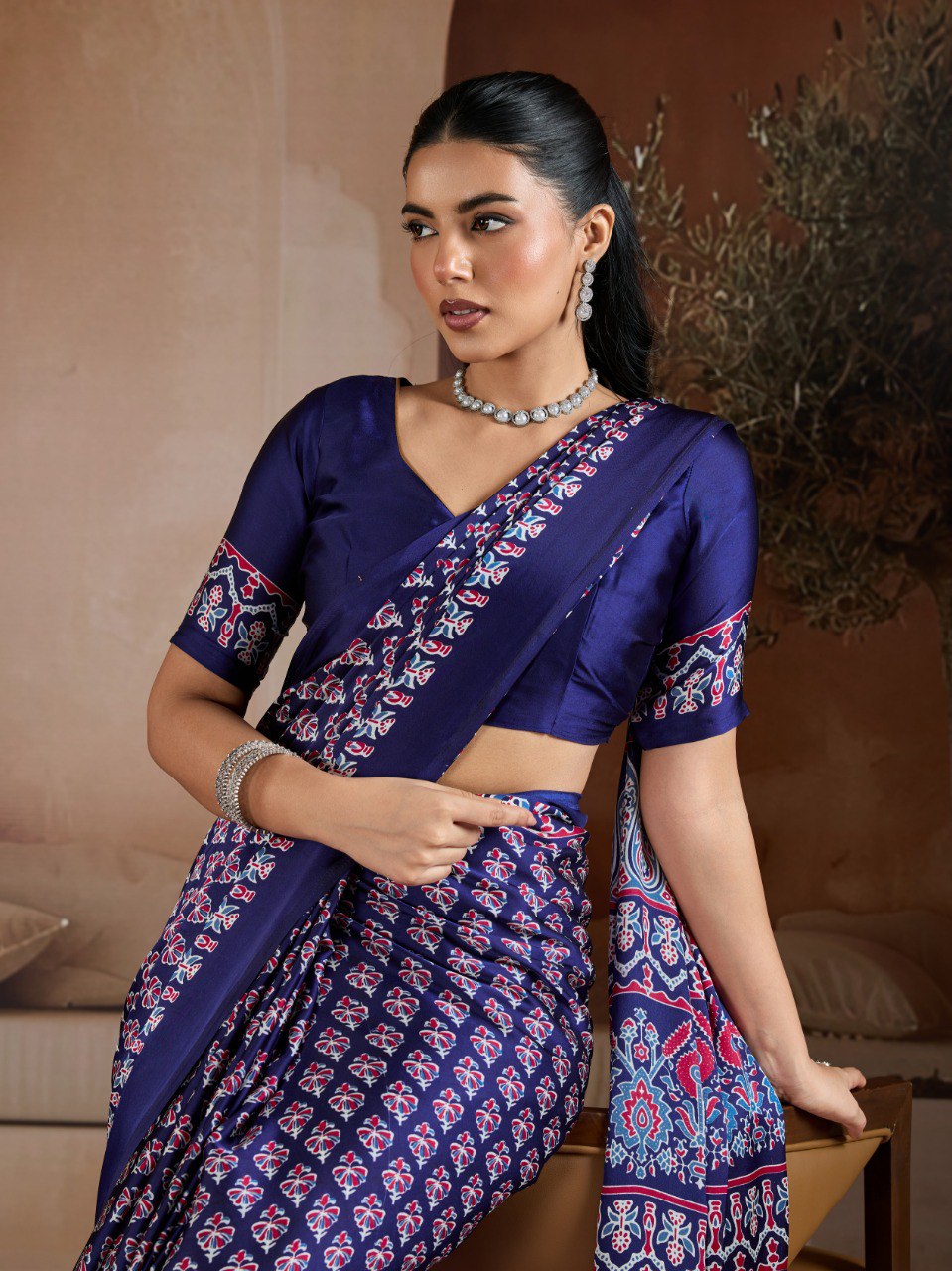 Pure Ajrakh modal satin fabric featuring traditional printed motifs with rich, earthy tones and a soft, breathable feel, perfect for all-day elegance.