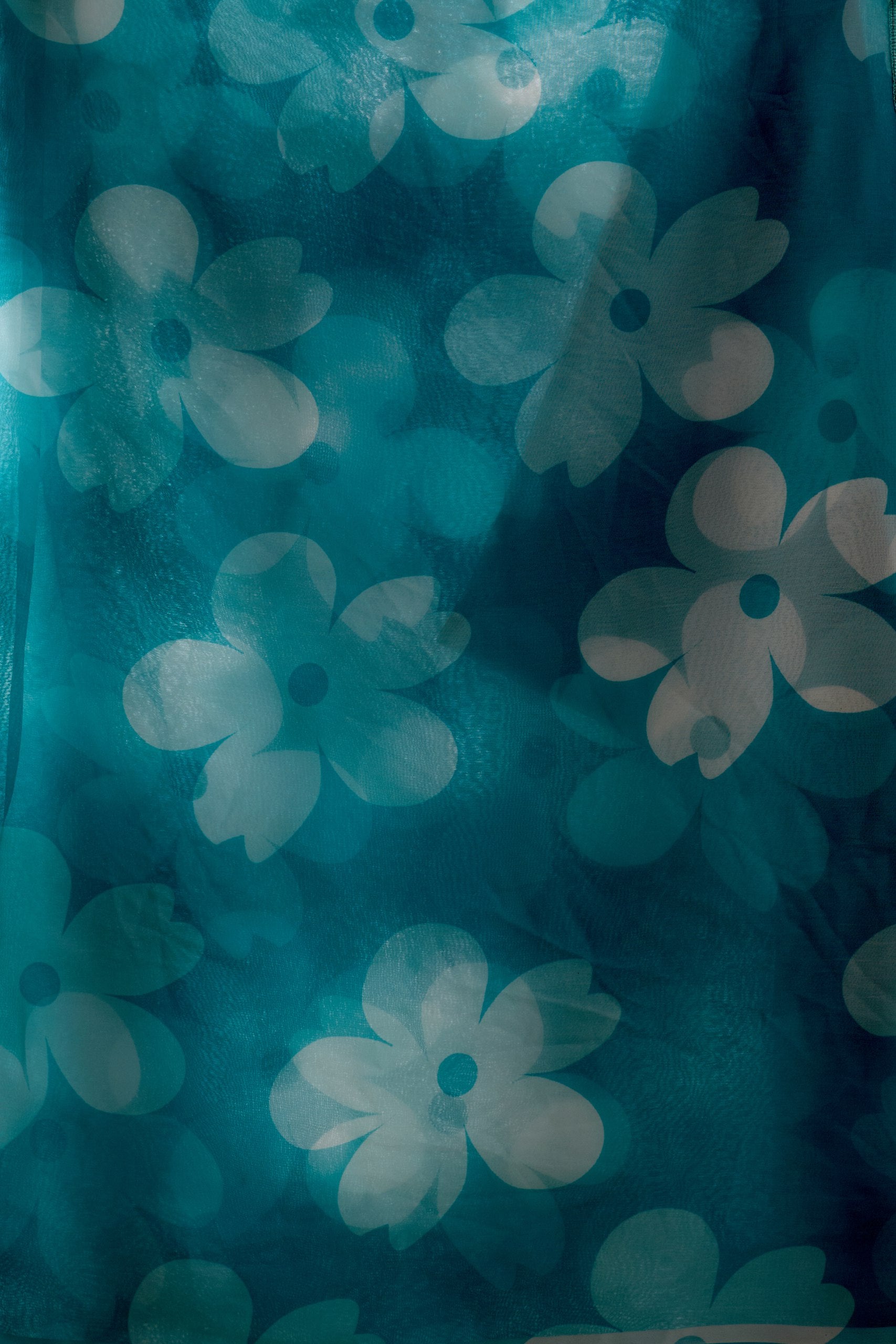 Soft Georgette Saree in Aqua Blue Shade Beautified with Bold White Oversized Floral Digital Print & Finished with Playful Tassel Detailing on Pallu