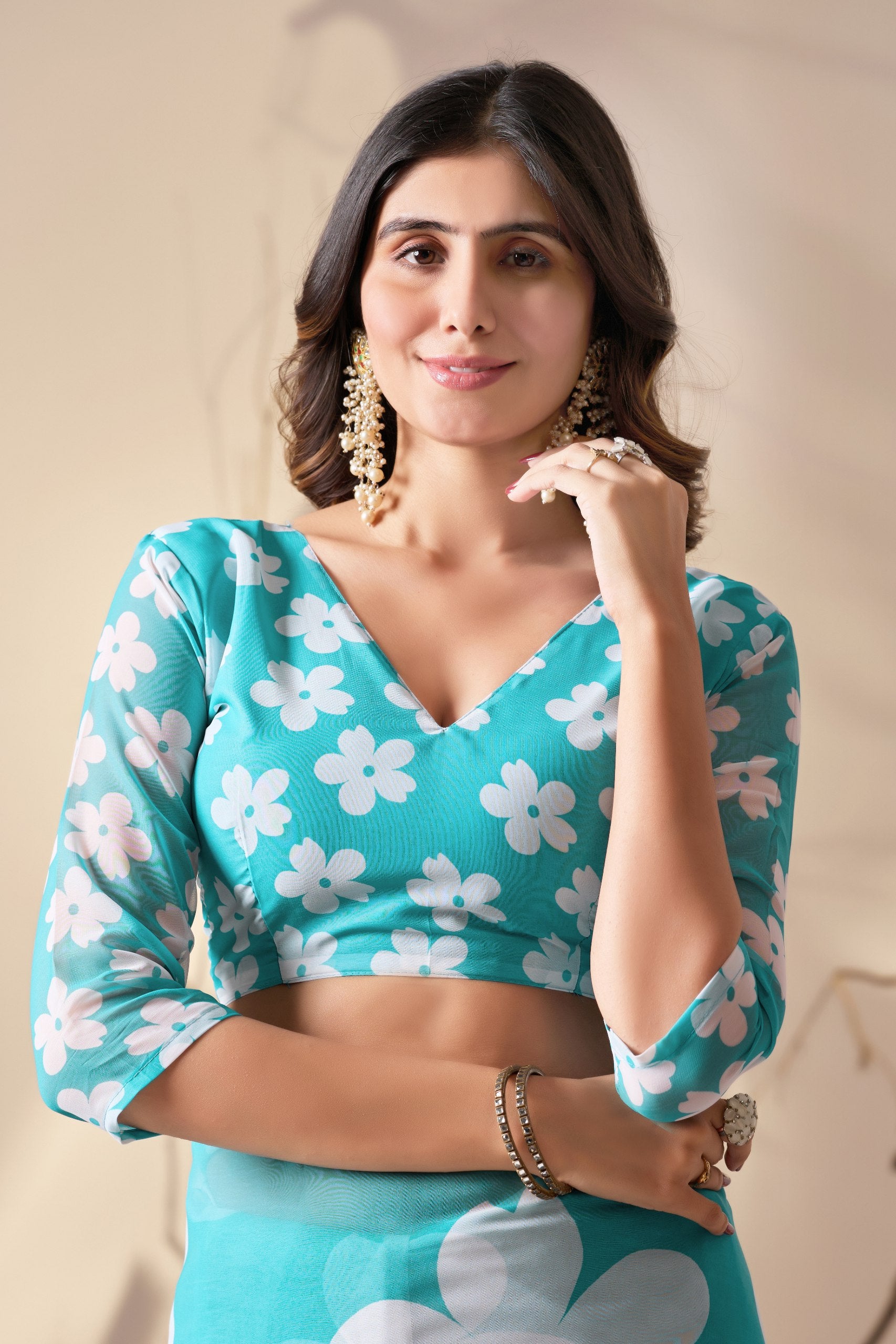 Soft Georgette Saree in Aqua Blue Shade Beautified with Bold White Oversized Floral Digital Print & Finished with Playful Tassel Detailing on Pallu