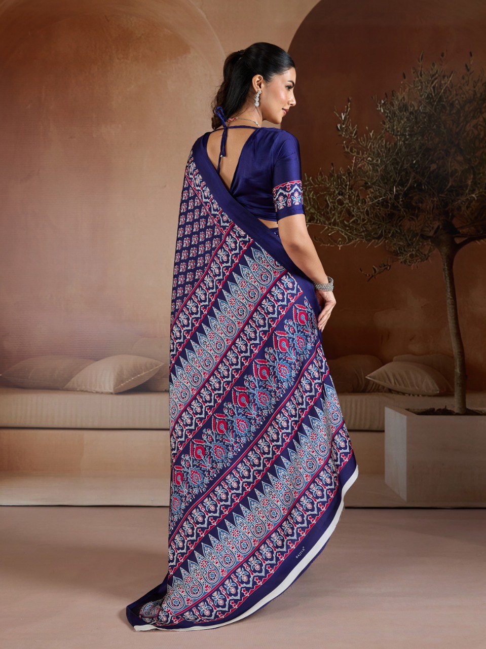 Pure Ajrakh modal satin fabric featuring traditional printed motifs with rich, earthy tones and a soft, breathable feel, perfect for all-day elegance.