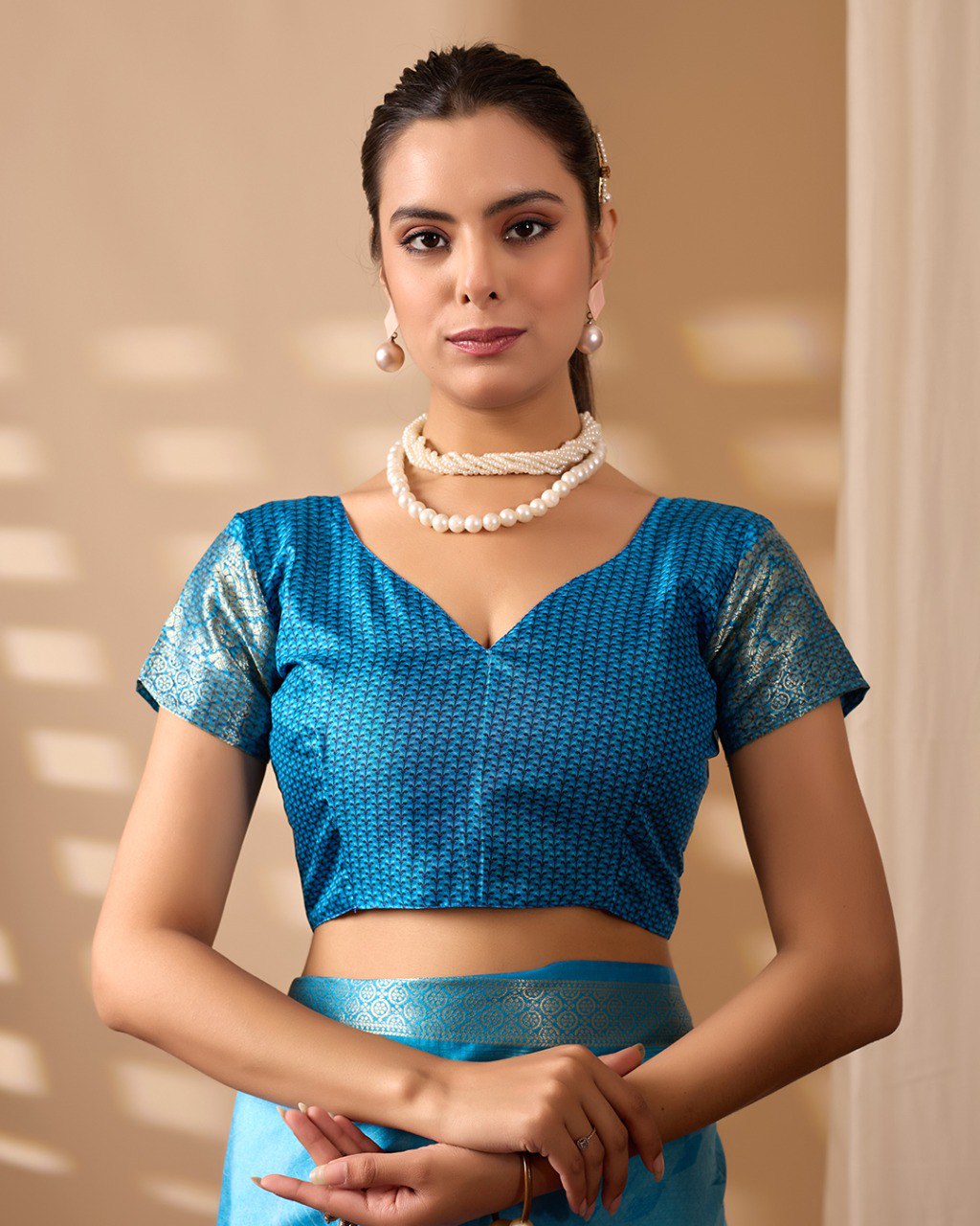 Soft Lichi Silk Saree in Serene Sky Blue Tone adorned with mesmerizing lotus-inspired digital prints and complemented by a luxurious golden zari woven border & pallu