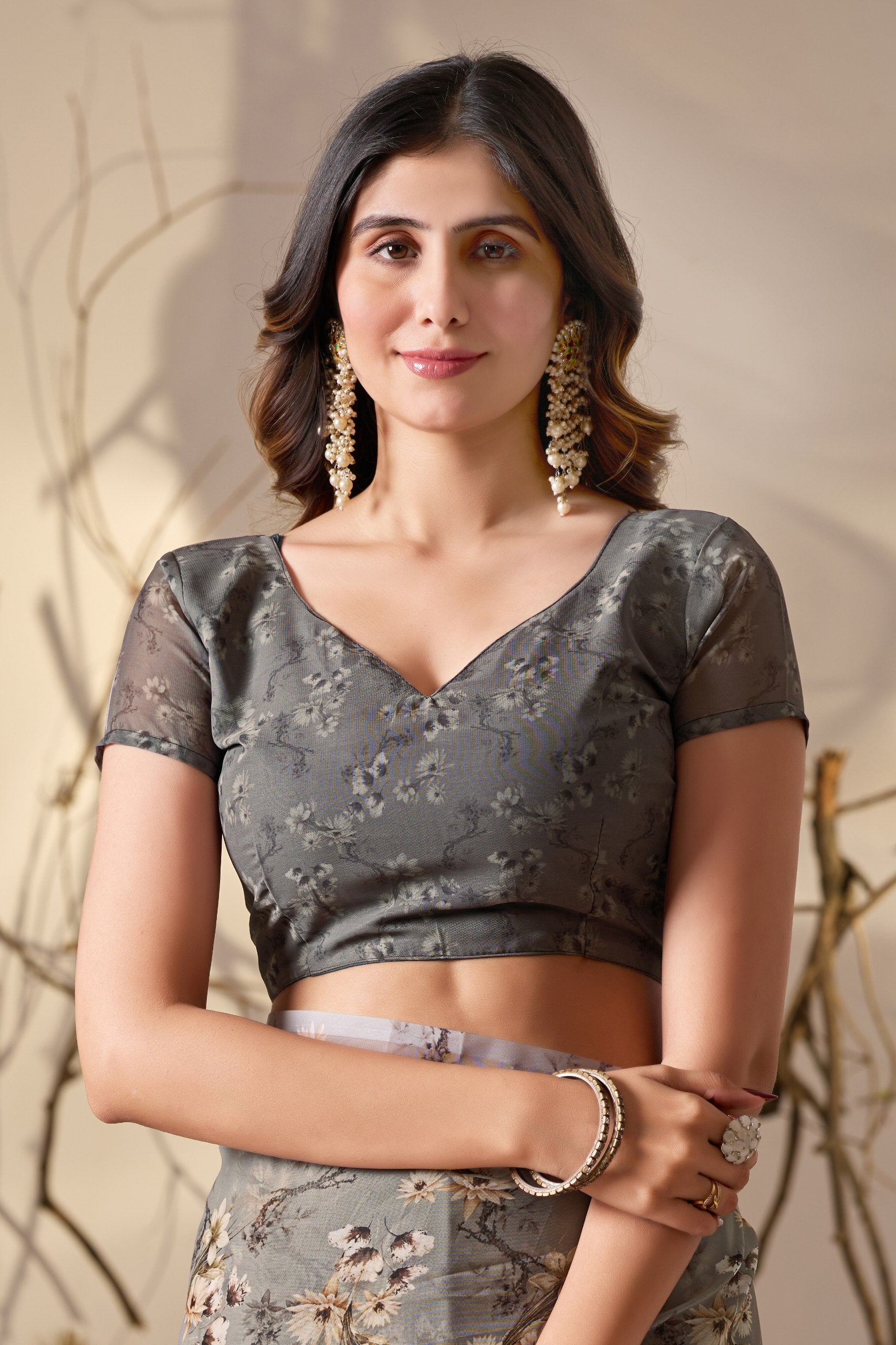 Soft Georgette Saree in Muted Grey Base Adorned with All-Over Floral Digital Print and Enhanced with Ornate Tribal-Style Patterned Pallu Featuring Pink, Black & Teal Accents + Elegant Black Tassel Detailing