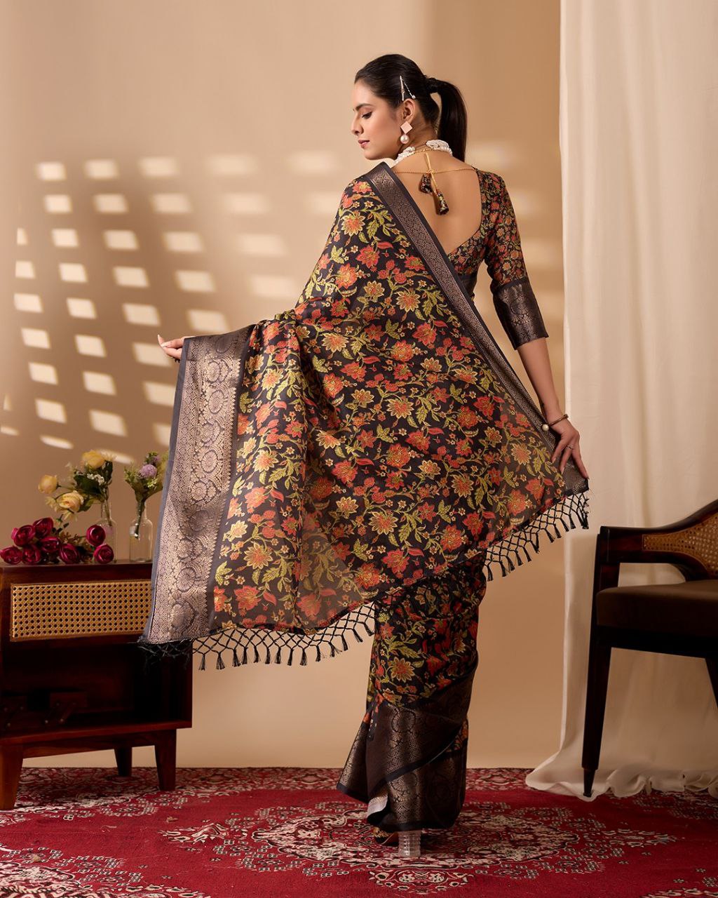 Exquisite Soft Lichi Silk Saree featuring stunning digital floral motifs on a rich black base, beautifully complemented by a luxurious golden zari border.