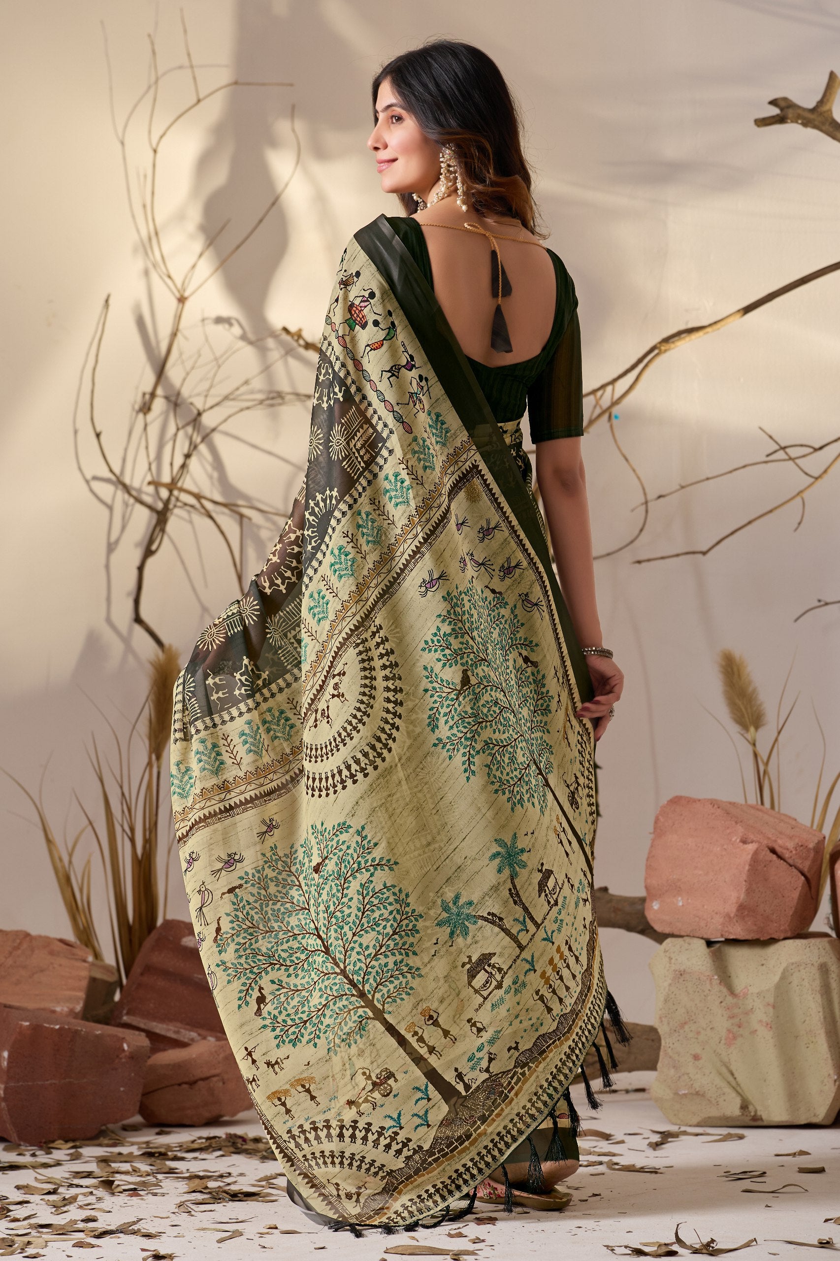 Soft Georgette Saree in Olive Green with Traditional Tribal Warli-Inspired Digital Prints and Rich Beige Panels Highlighted with Nature, Dance & Village Motifs + Intricate Tassel Detailing on the Pallu