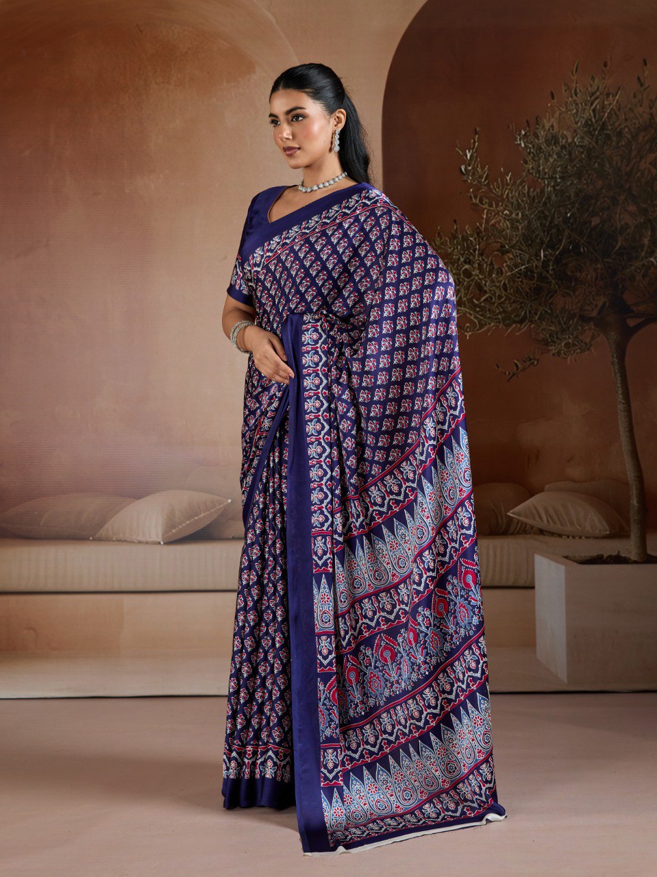 Pure Ajrakh modal satin fabric featuring traditional printed motifs with rich, earthy tones and a soft, breathable feel, perfect for all-day elegance.