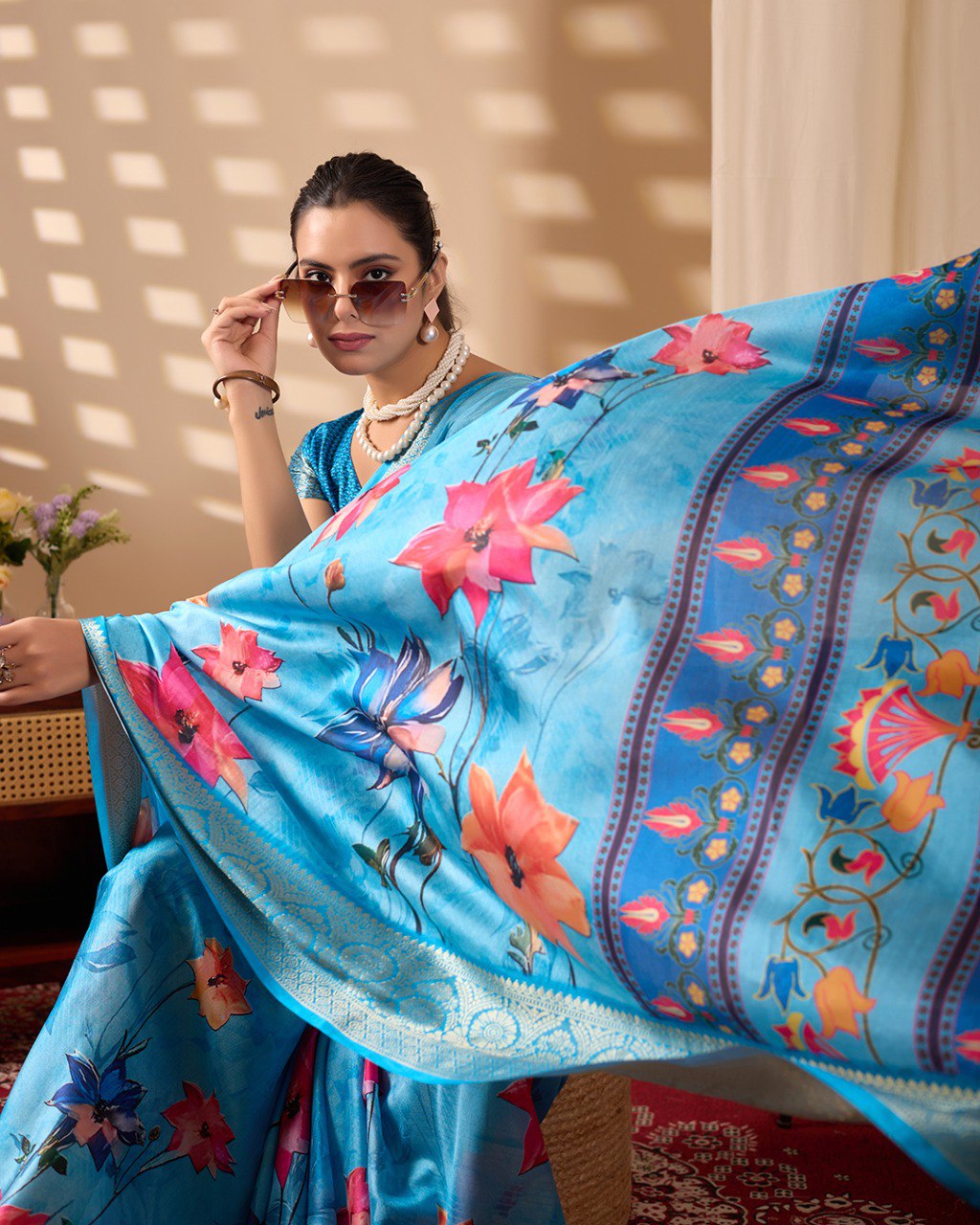 Soft Lichi Silk Saree in Serene Sky Blue Tone adorned with mesmerizing lotus-inspired digital prints and complemented by a luxurious golden zari woven border & pallu