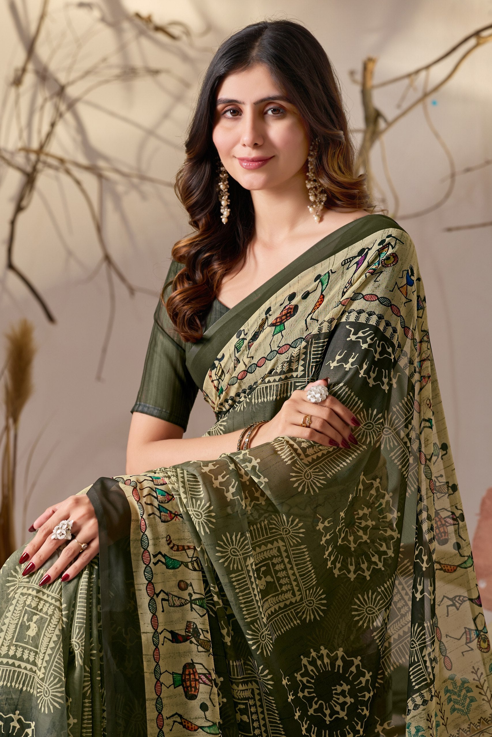 Soft Georgette Saree in Olive Green with Traditional Tribal Warli-Inspired Digital Prints and Rich Beige Panels Highlighted with Nature, Dance & Village Motifs + Intricate Tassel Detailing on the Pallu