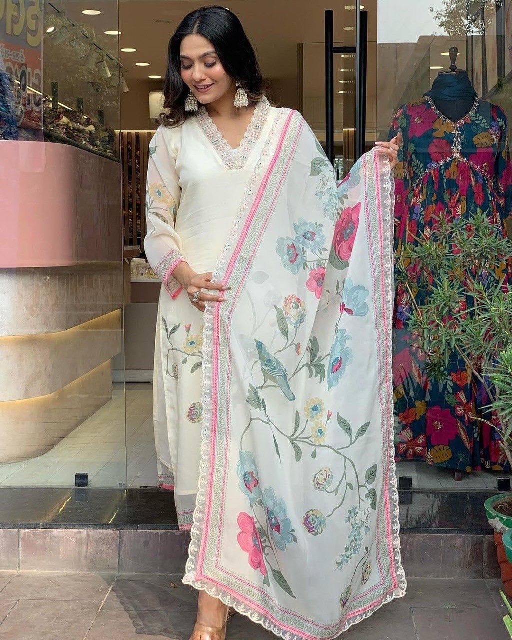 Off White  Color Suit Set  seems to be a party wear outfit made from TB Silk fabric with digital Prints TB Silk Duptta wih Embroidery sequence Lace.(3-Pair)