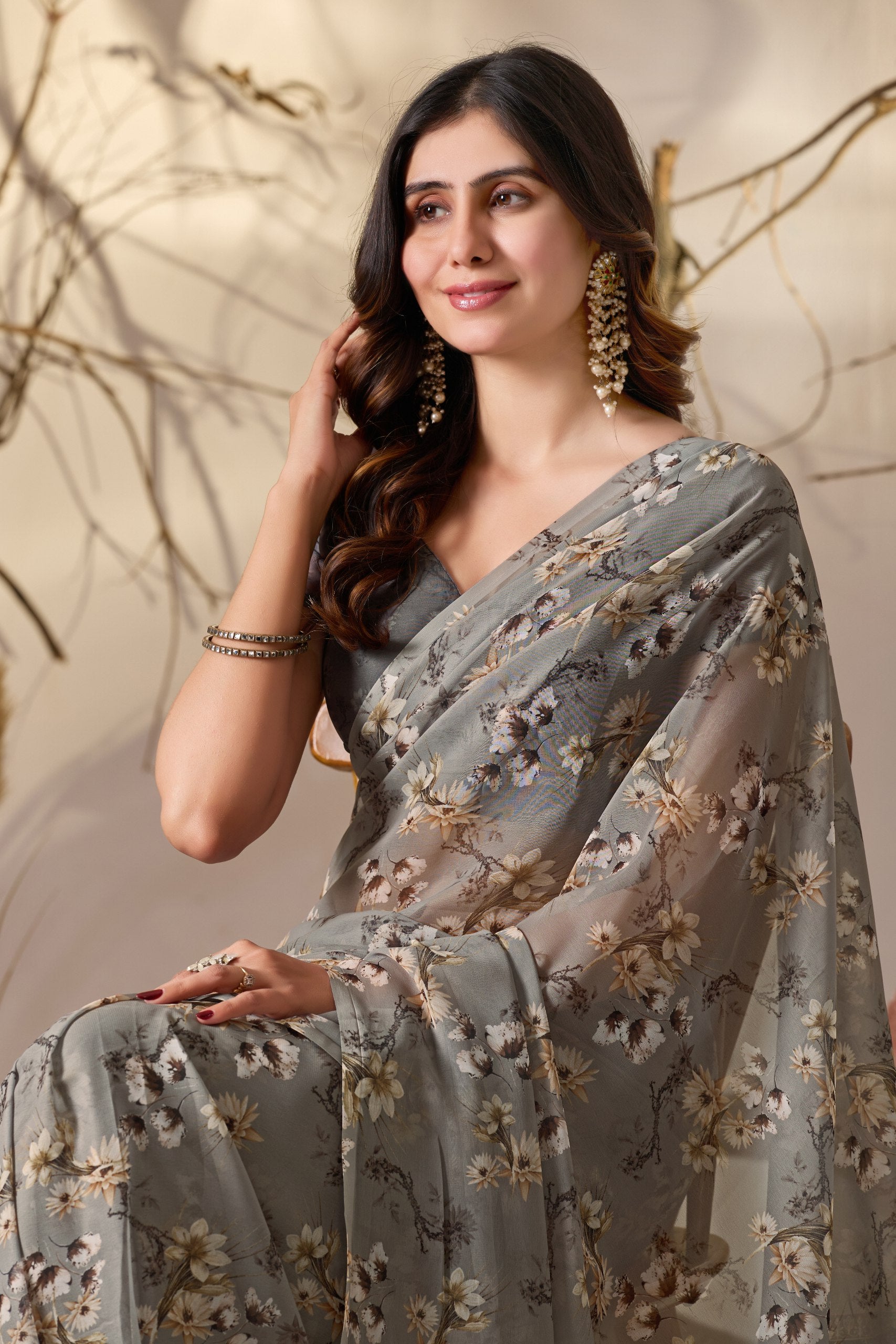 Soft Georgette Saree in Muted Grey Base Adorned with All-Over Floral Digital Print and Enhanced with Ornate Tribal-Style Patterned Pallu Featuring Pink, Black & Teal Accents + Elegant Black Tassel Detailing