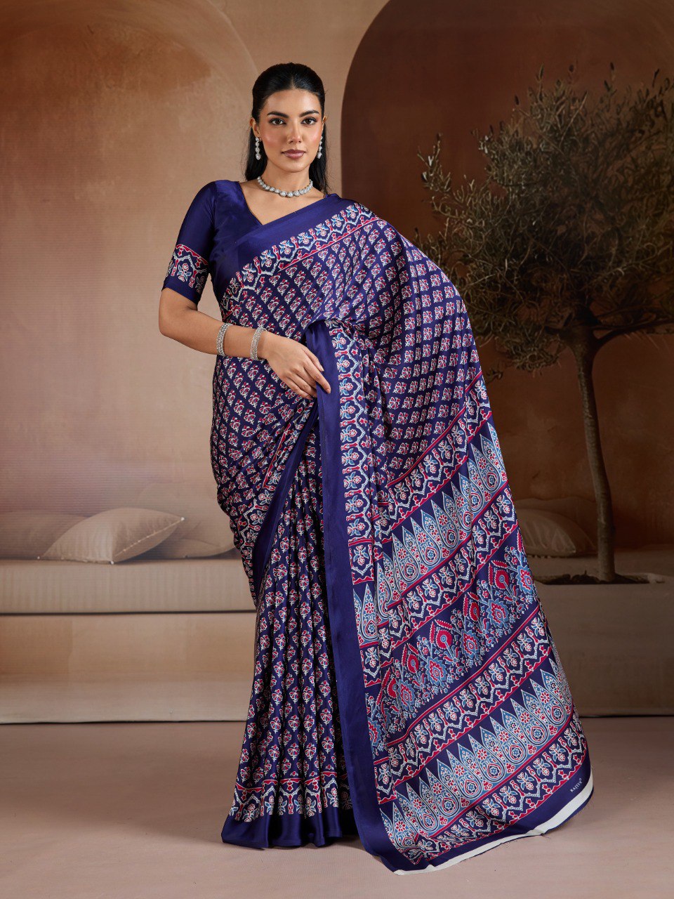 Pure Ajrakh modal satin fabric featuring traditional printed motifs with rich, earthy tones and a soft, breathable feel, perfect for all-day elegance.