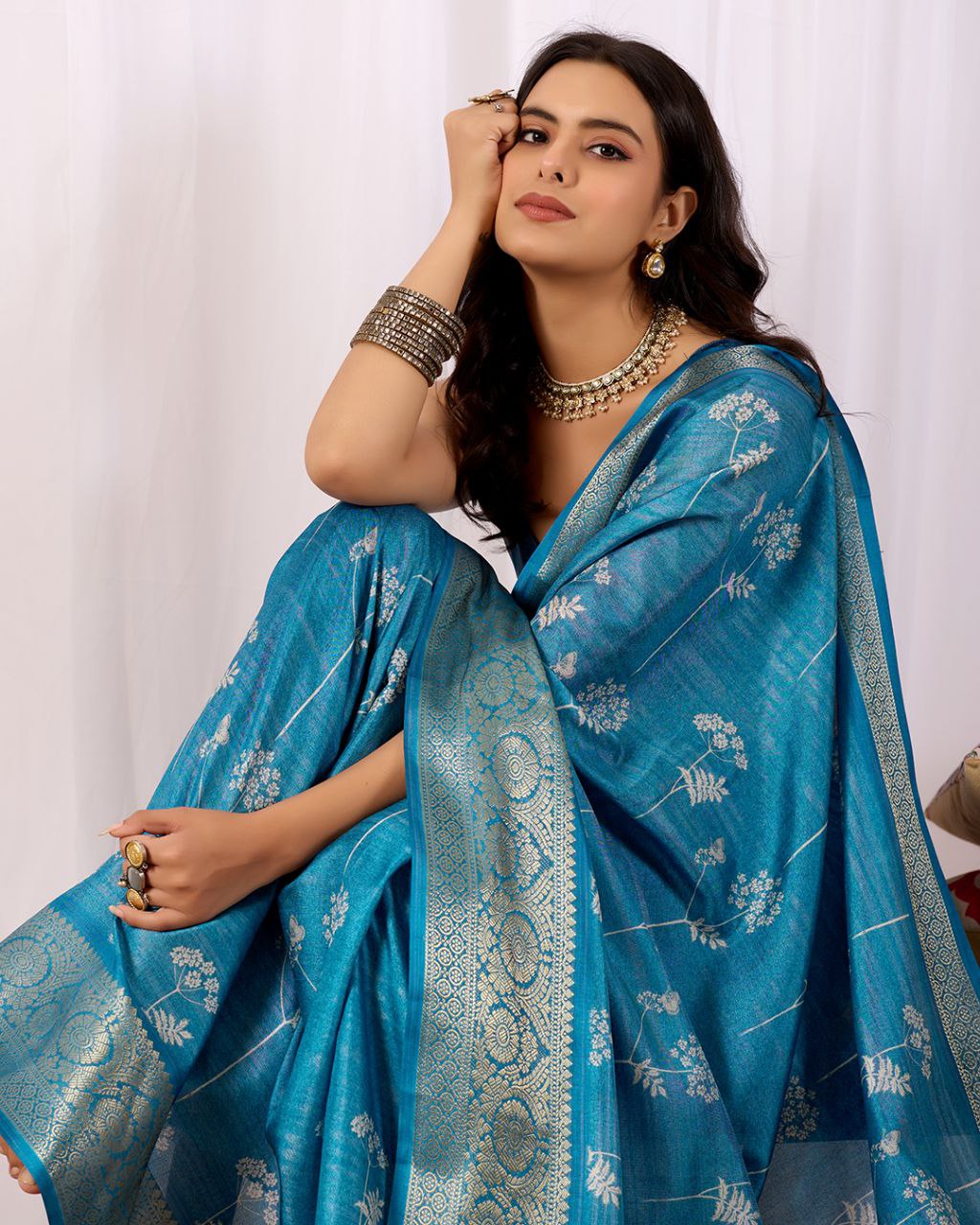Premium Soft Lichi Silk Saree highlighted with graceful silver zari weaving and intricate ethnic motifs — radiating sheer elegance and royal charm in every drape.