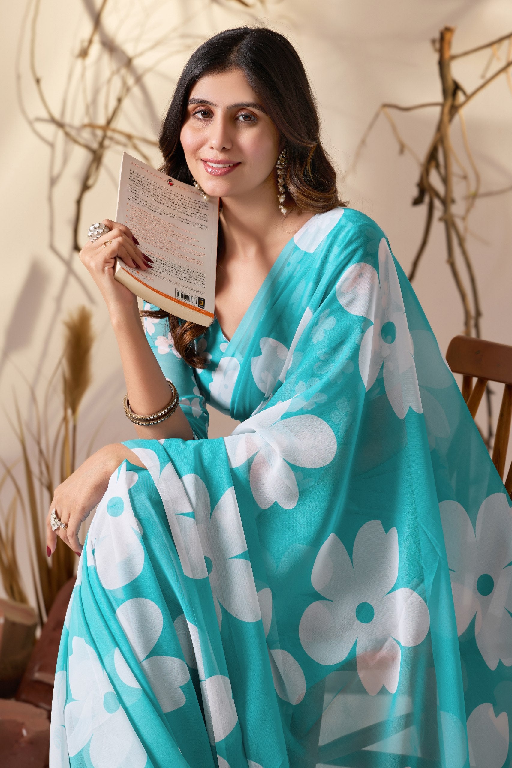 Soft Georgette Saree in Aqua Blue Shade Beautified with Bold White Oversized Floral Digital Print & Finished with Playful Tassel Detailing on Pallu