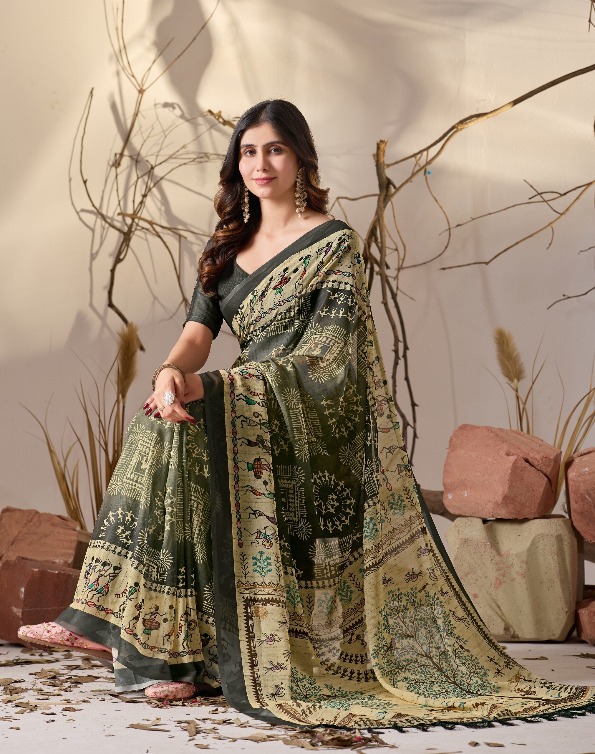 Soft Georgette Saree in Olive Green with Traditional Tribal Warli-Inspired Digital Prints and Rich Beige Panels Highlighted with Nature, Dance & Village Motifs + Intricate Tassel Detailing on the Pallu