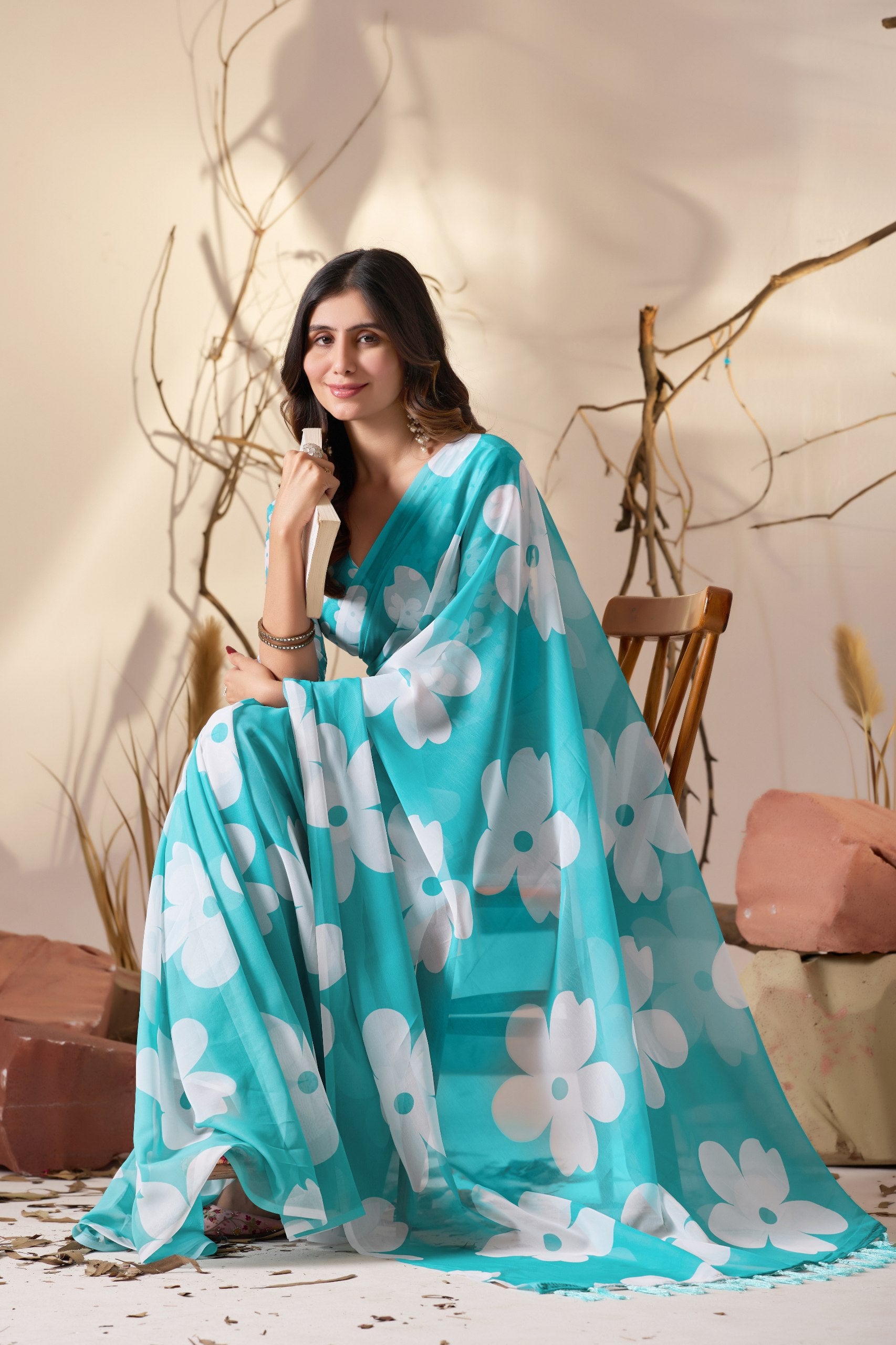 Soft Georgette Saree in Aqua Blue Shade Beautified with Bold White Oversized Floral Digital Print & Finished with Playful Tassel Detailing on Pallu