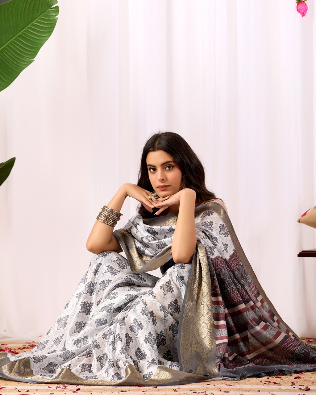 Premium Soft Lichi Silk Saree in Elegant White Base featuring intricate black ethnic motifs, beautifully complemented with a luxurious golden zari woven border and a rich maroon pallu