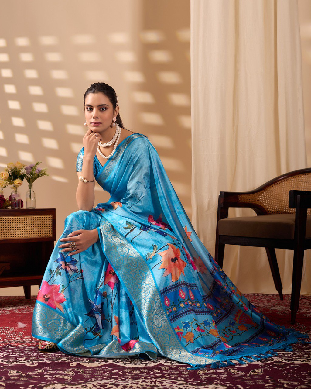 Soft Lichi Silk Saree in Serene Sky Blue Tone adorned with mesmerizing lotus-inspired digital prints and complemented by a luxurious golden zari woven border & pallu