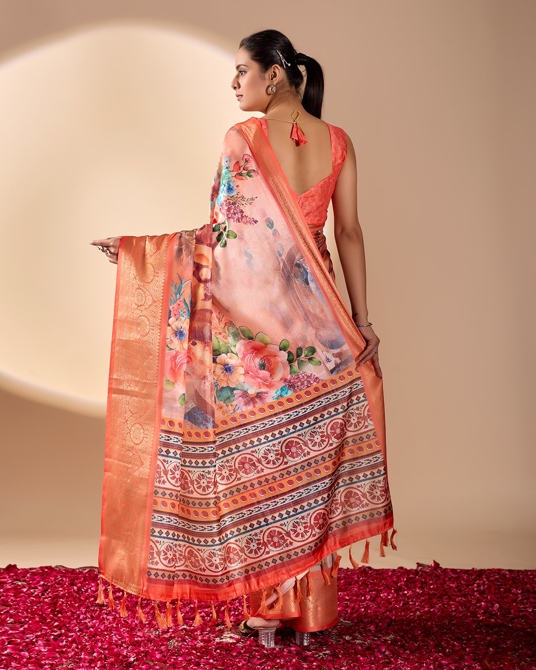 Soft Lichi Silk Saree adorned with elegant floral patterns and intricate Patola-inspired pallu, complemented by a luxurious zari woven border