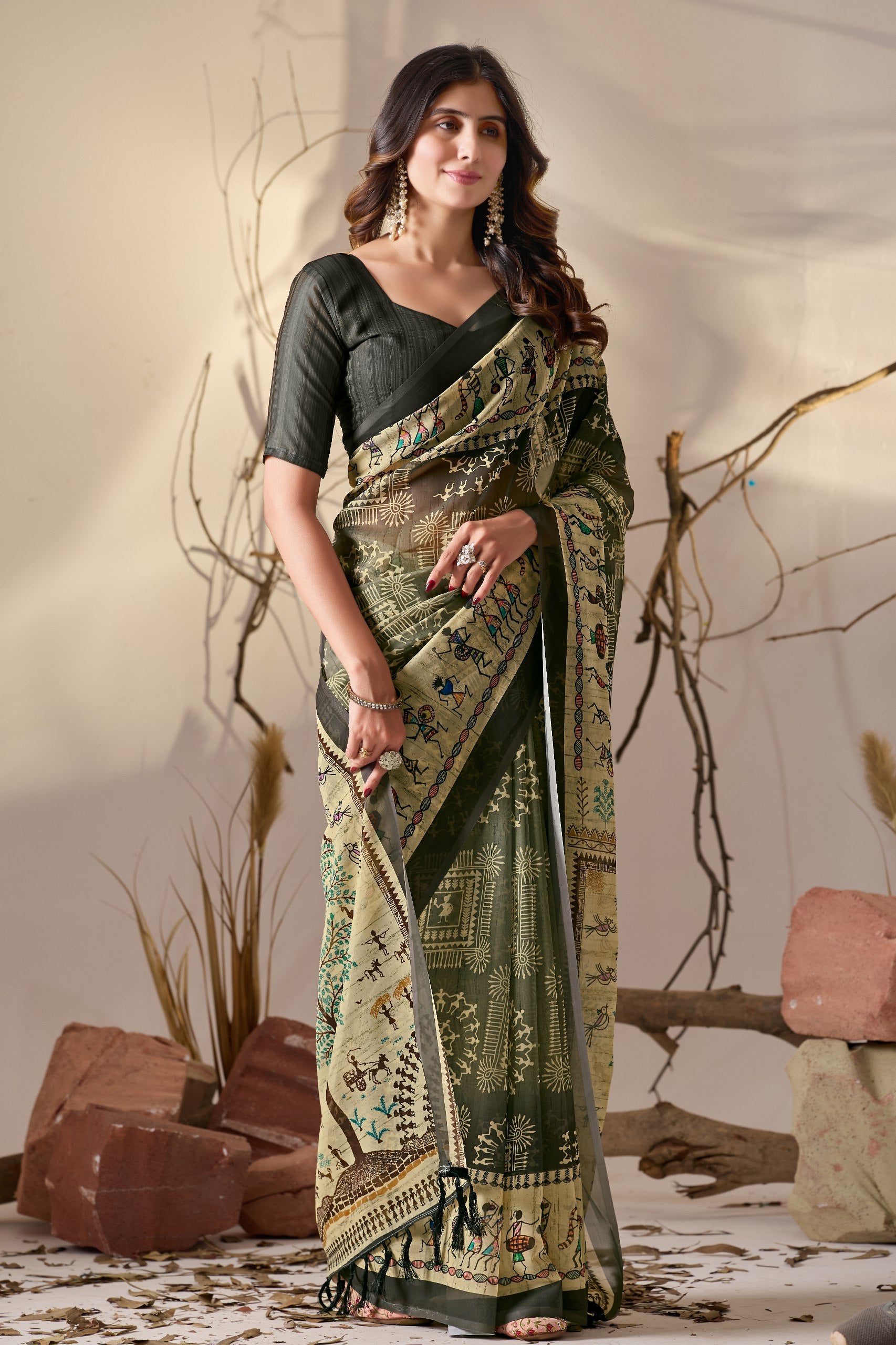 Soft Georgette Saree in Olive Green with Traditional Tribal Warli-Inspired Digital Prints and Rich Beige Panels Highlighted with Nature, Dance & Village Motifs + Intricate Tassel Detailing on the Pallu