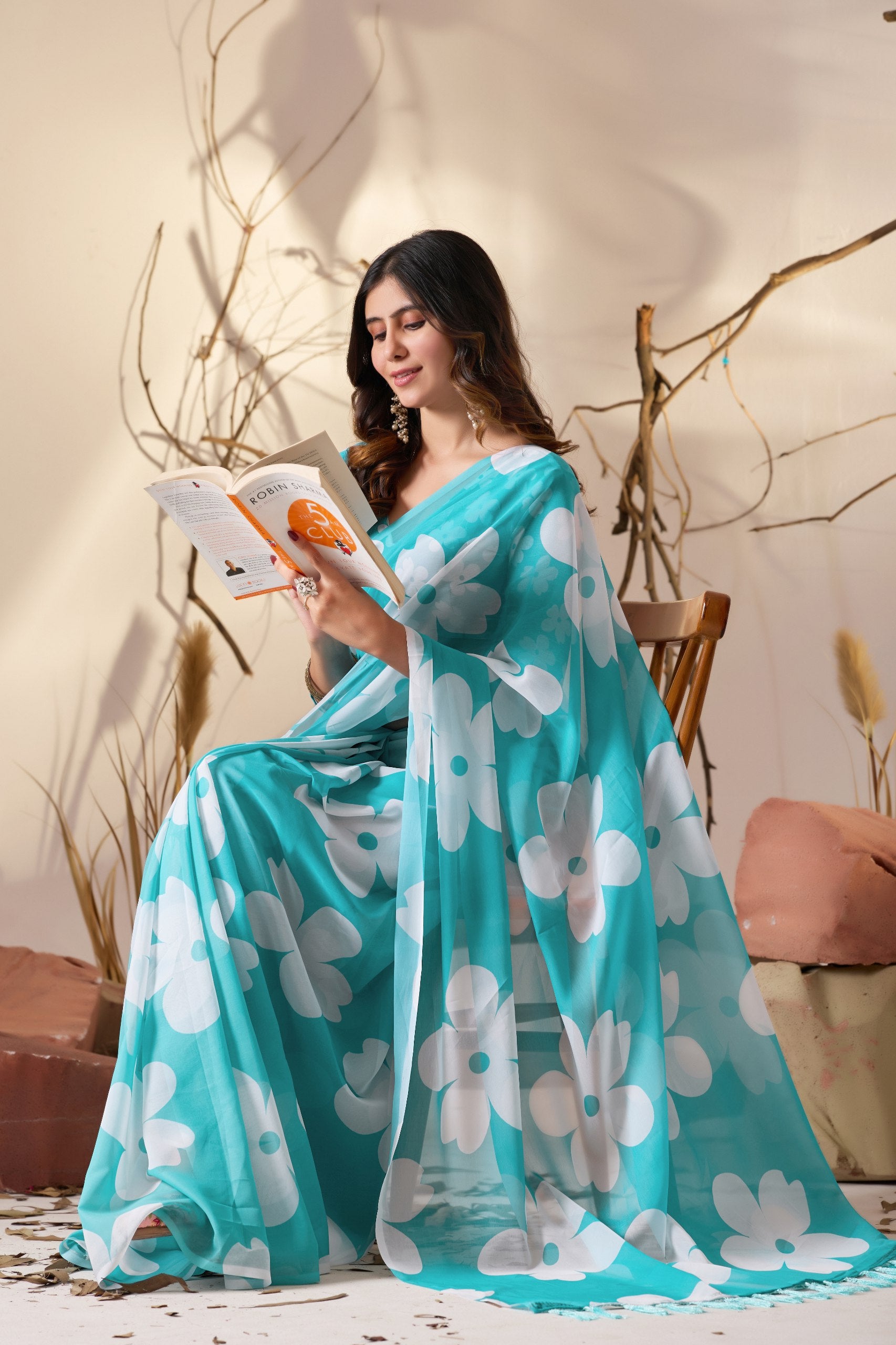 Soft Georgette Saree in Aqua Blue Shade Beautified with Bold White Oversized Floral Digital Print & Finished with Playful Tassel Detailing on Pallu