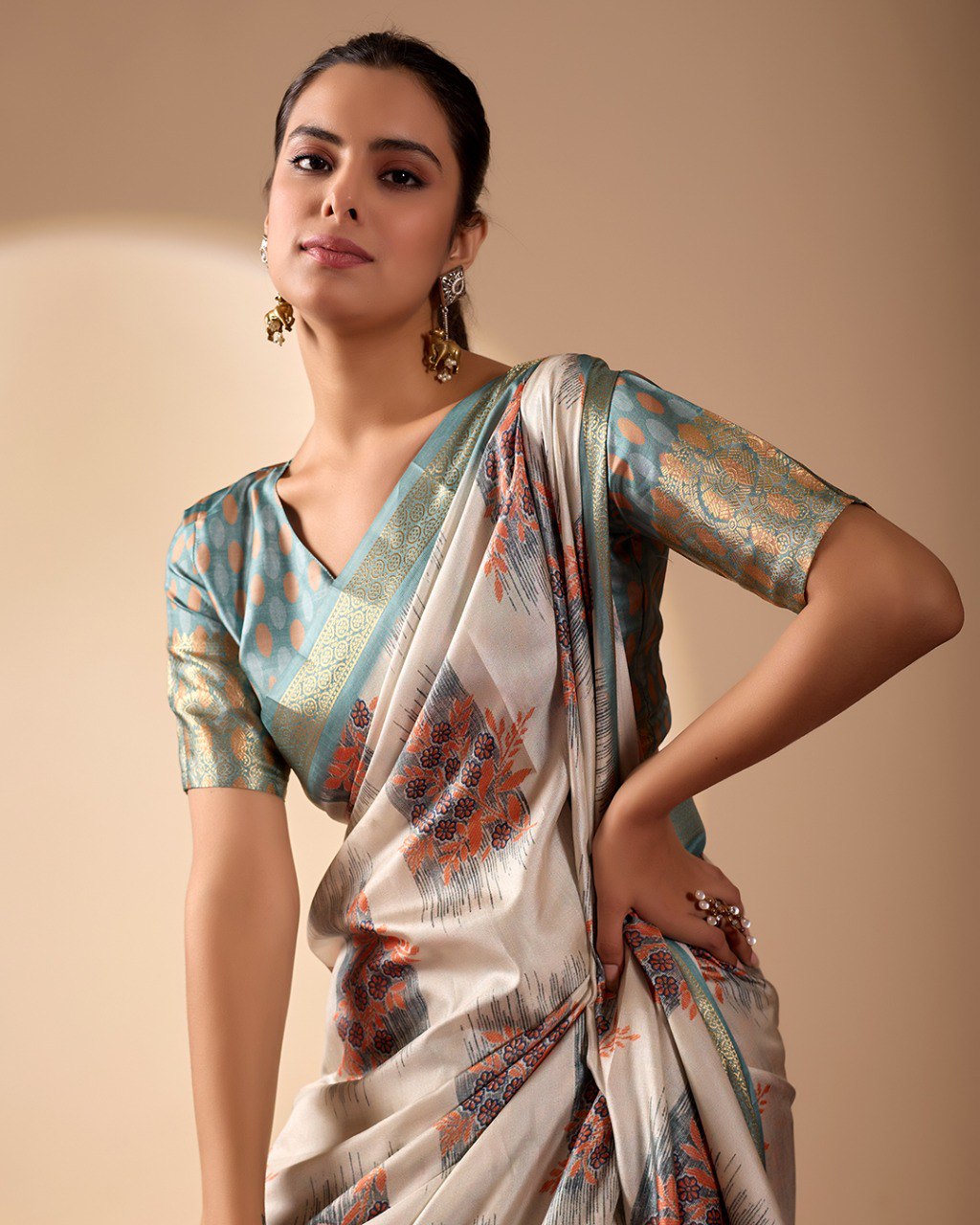 Elegant Soft Lichi Silk Saree in a refined ivory and teal tone, featuring traditional motifs and intricate digital prints enhanced with a golden zari border.
