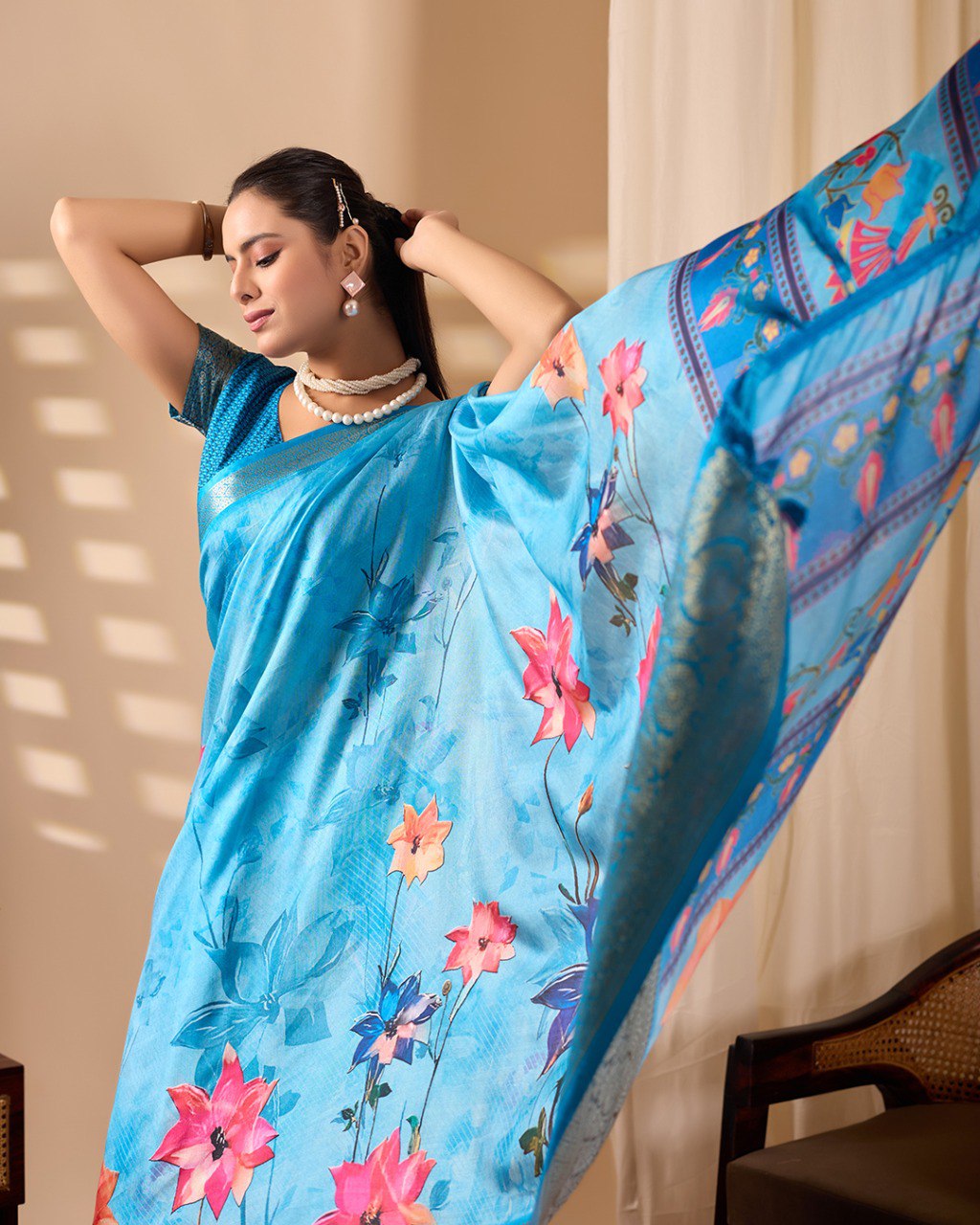 Soft Lichi Silk Saree in Serene Sky Blue Tone adorned with mesmerizing lotus-inspired digital prints and complemented by a luxurious golden zari woven border & pallu