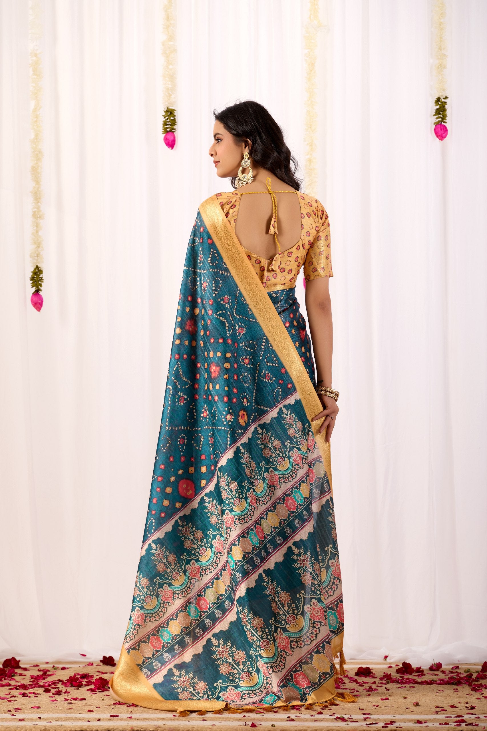 Soft Lichi Silk Saree featuring an Elegant Tribal Art Print complemented by a Luxurious Rich Zari Border. The blend of traditional artistry and silky sheen adds a royal touch to your festive look.