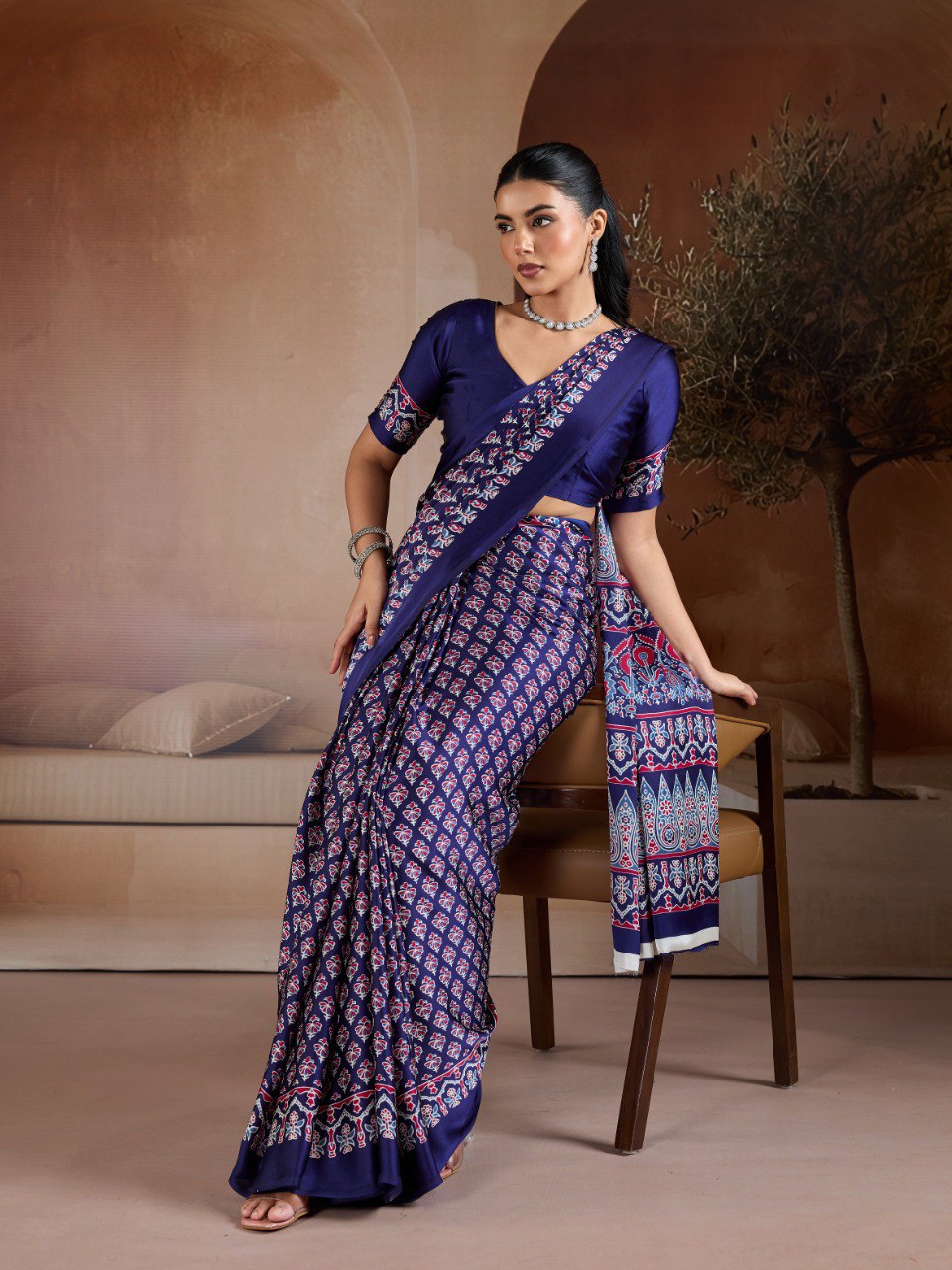 Pure Ajrakh modal satin fabric featuring traditional printed motifs with rich, earthy tones and a soft, breathable feel, perfect for all-day elegance.