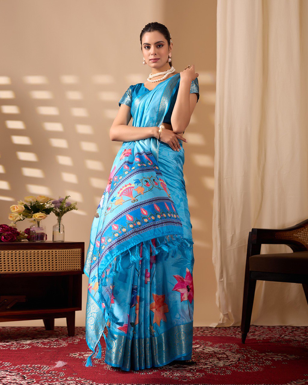 Soft Lichi Silk Saree in Serene Sky Blue Tone adorned with mesmerizing lotus-inspired digital prints and complemented by a luxurious golden zari woven border & pallu