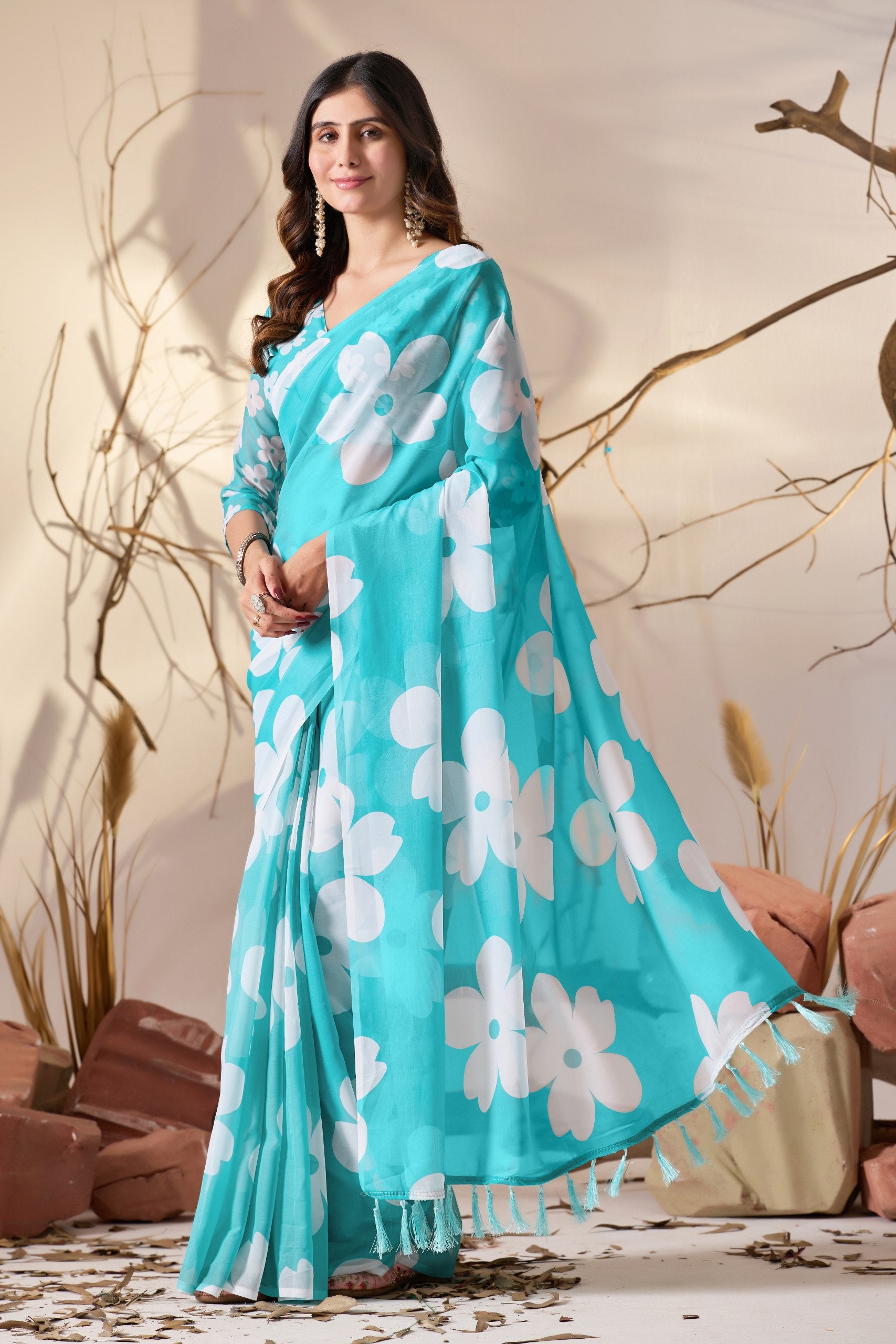 Soft Georgette Saree in Aqua Blue Shade Beautified with Bold White Oversized Floral Digital Print & Finished with Playful Tassel Detailing on Pallu