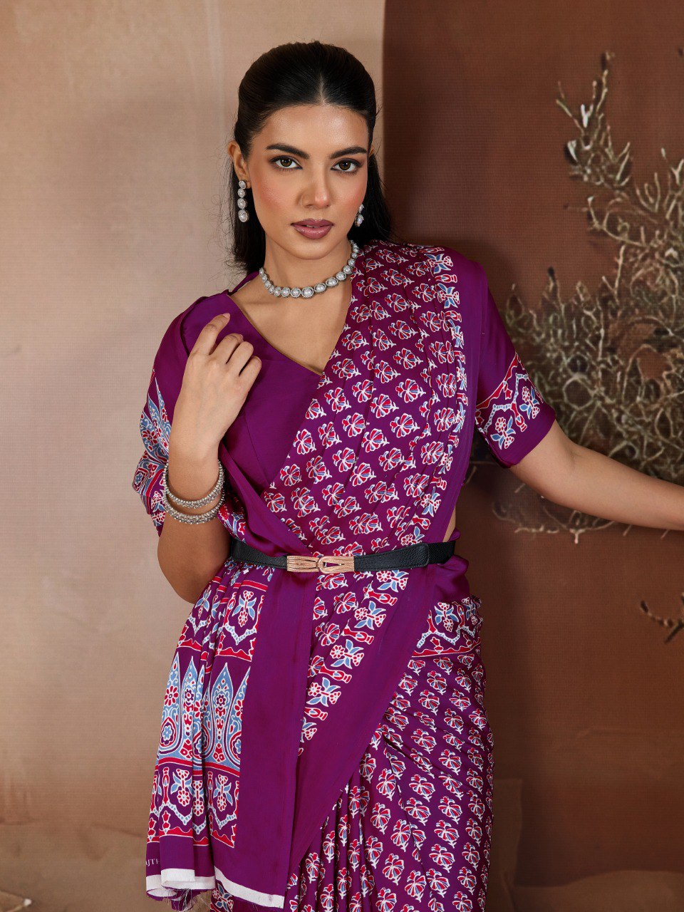 Pure Ajrakh modal satin fabric featuring traditional printed motifs with rich, earthy tones and a soft, breathable feel, perfect for all-day elegance.