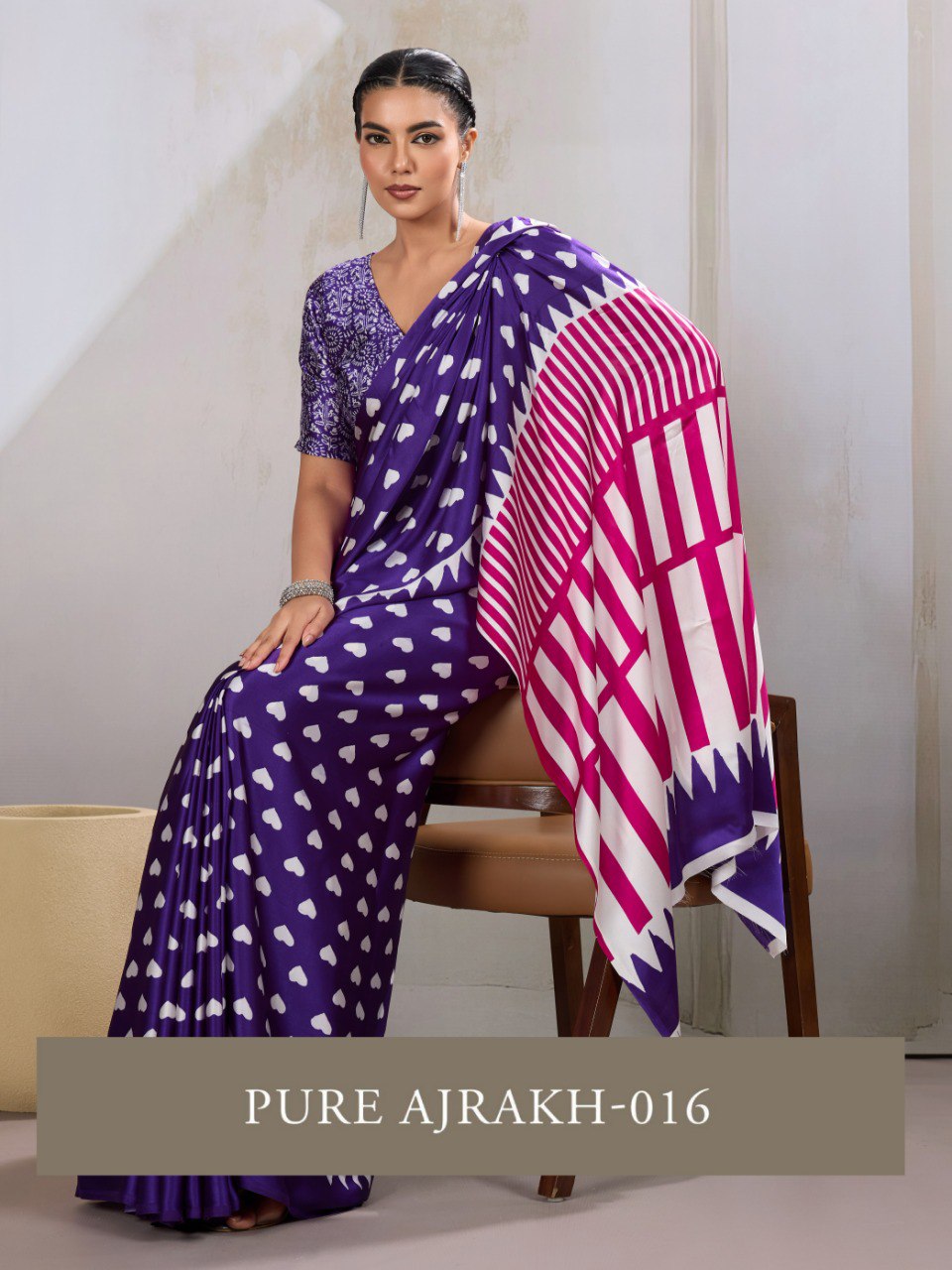 Pure Ajrakh modal satin fabric featuring traditional printed motifs with rich, earthy tones and a soft, breathable feel, perfect for all-day elegance.