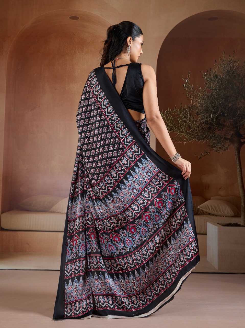 Pure Ajrakh modal satin fabric featuring traditional printed motifs with rich, earthy tones and a soft, breathable feel, perfect for all-day elegance.