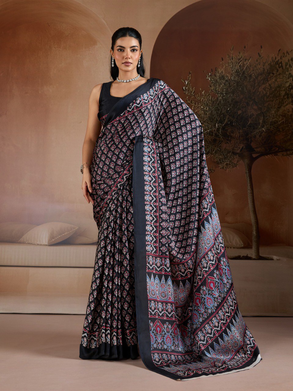 Pure Ajrakh modal satin fabric featuring traditional printed motifs with rich, earthy tones and a soft, breathable feel, perfect for all-day elegance.