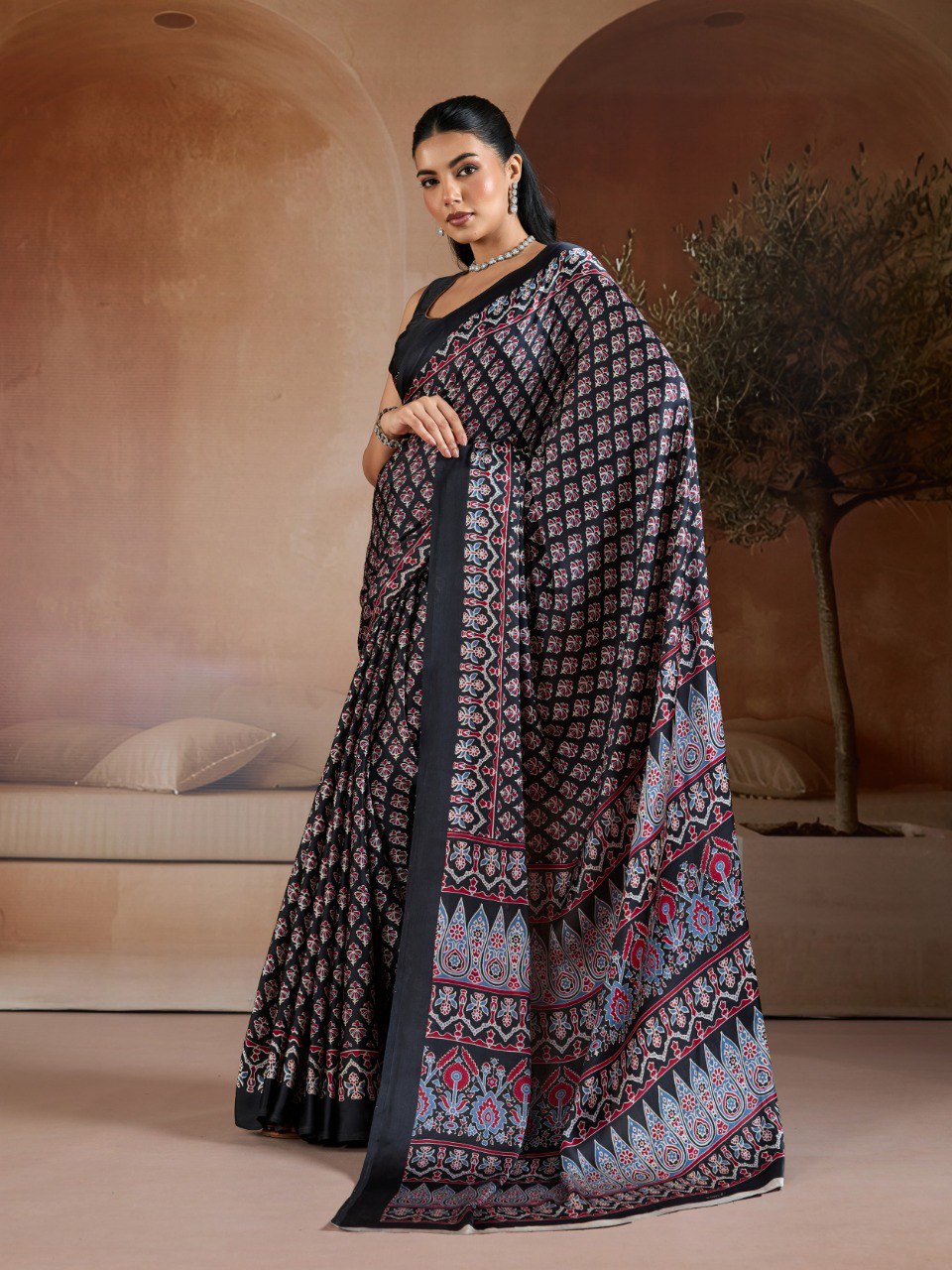 Pure Ajrakh modal satin fabric featuring traditional printed motifs with rich, earthy tones and a soft, breathable feel, perfect for all-day elegance.