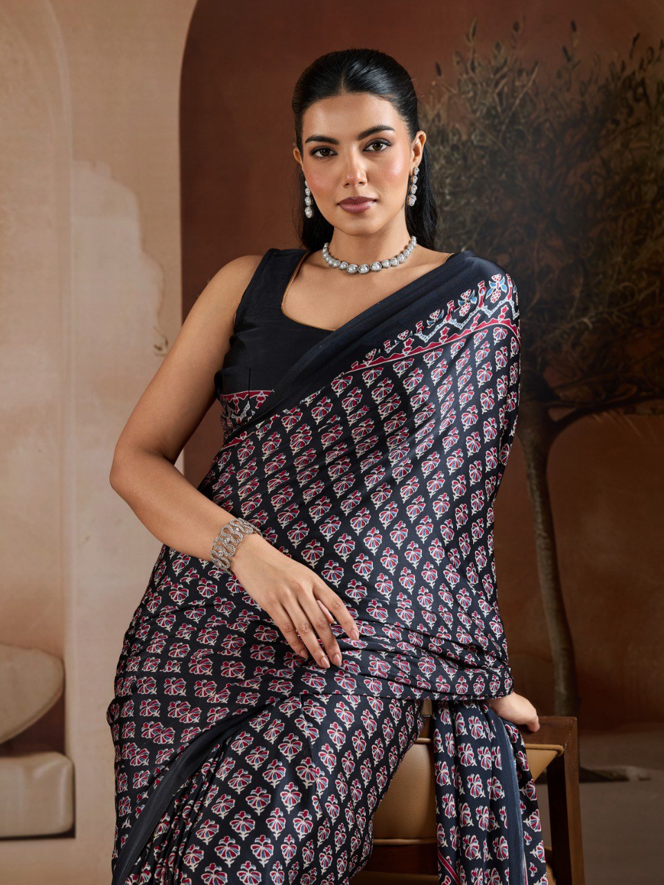 Pure Ajrakh modal satin fabric featuring traditional printed motifs with rich, earthy tones and a soft, breathable feel, perfect for all-day elegance.