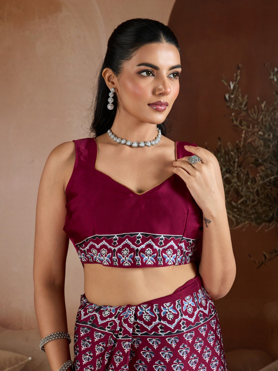 Pure Ajrakh modal satin fabric featuring traditional printed motifs with rich, earthy tones and a soft, breathable feel, perfect for all-day elegance.