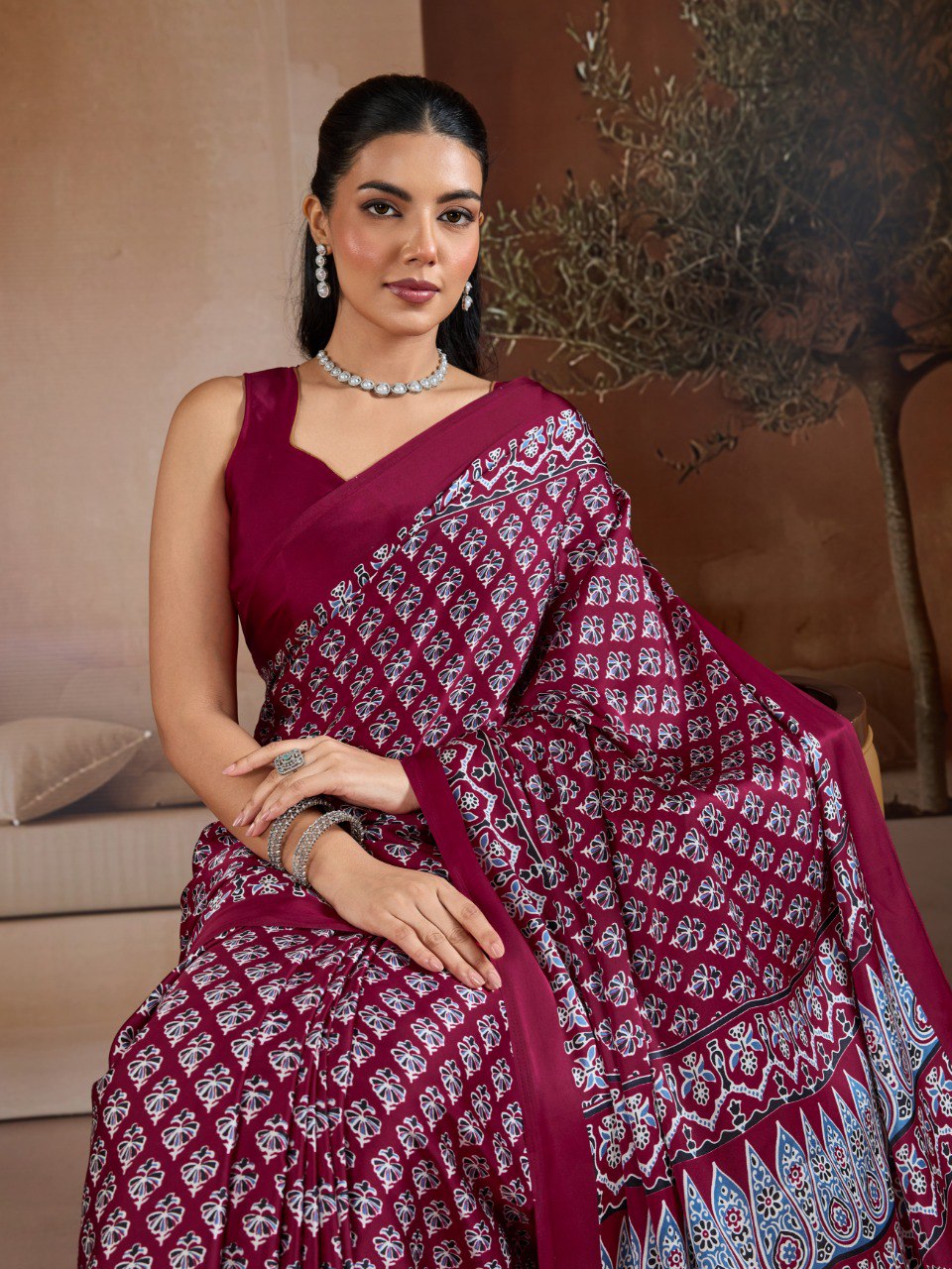Pure Ajrakh modal satin fabric featuring traditional printed motifs with rich, earthy tones and a soft, breathable feel, perfect for all-day elegance.