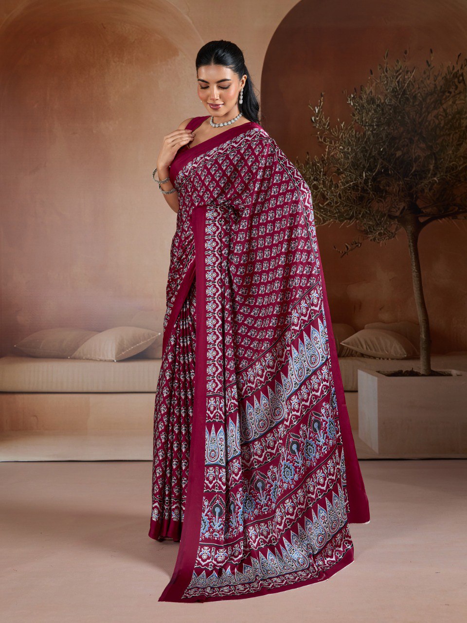 Pure Ajrakh modal satin fabric featuring traditional printed motifs with rich, earthy tones and a soft, breathable feel, perfect for all-day elegance.