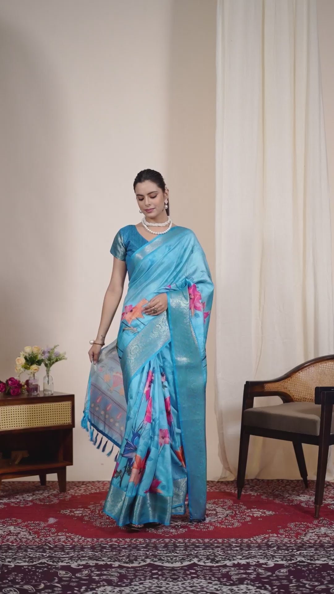 Soft Lichi Silk Saree in Serene Sky Blue Tone adorned with mesmerizing lotus-inspired digital prints and complemented by a luxurious golden zari woven border & pallu