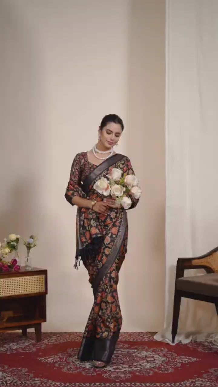Exquisite Soft Lichi Silk Saree featuring stunning digital floral motifs on a rich black base, beautifully complemented by a luxurious golden zari border.