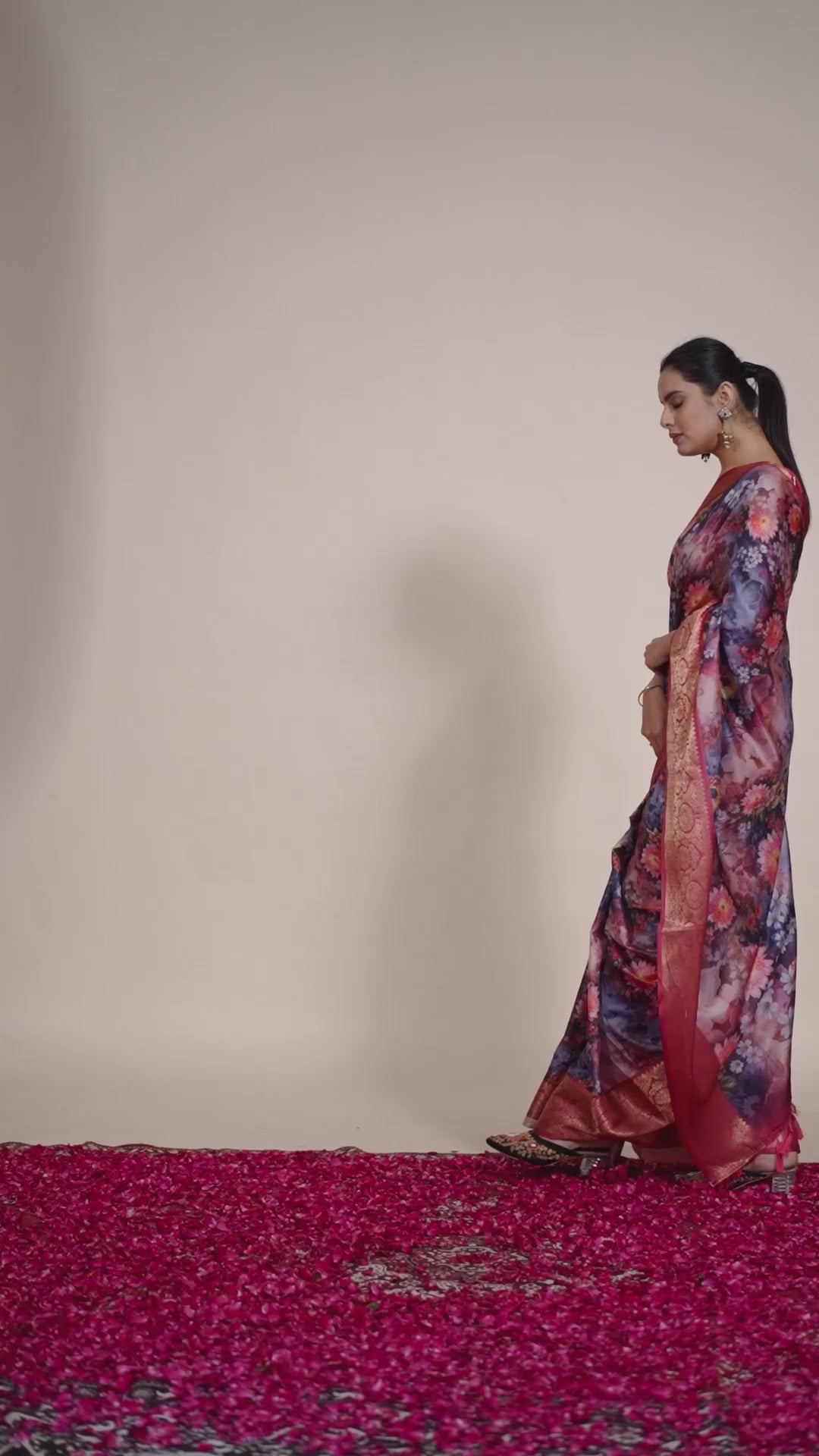 Luxurious Soft Lichi Silk Saree in Deep Wine Rose Shade featuring enchanting floral digital prints and complemented by a rich woven zari border & pallu — an epitome of elegance, beauty, and sophistication.